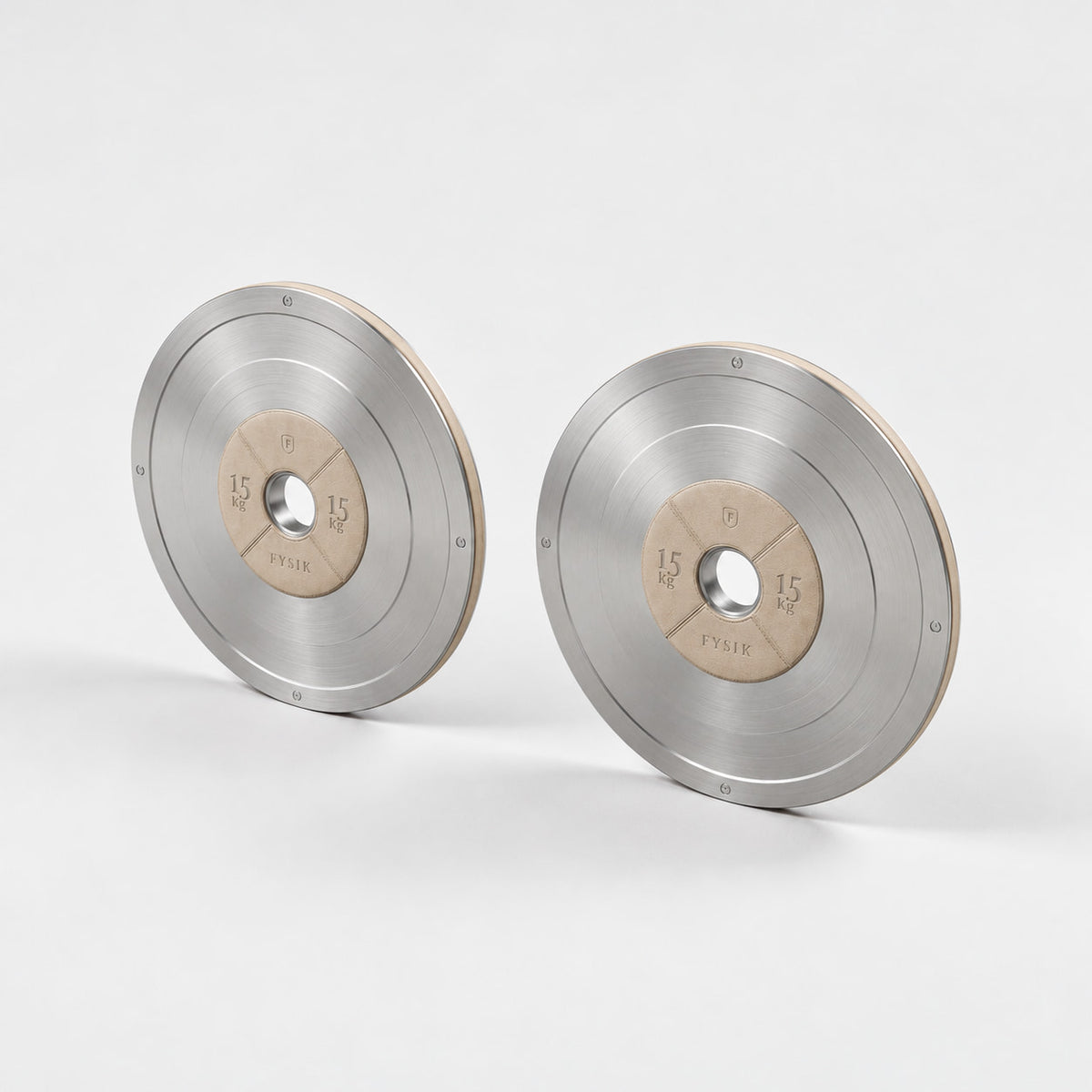 Klom Weight Plates Pair — angled view; Grey Ash wood, beige leather and natural stainless steel where applicable. FYSIK studio finish study — October 2026. Representative configuration.