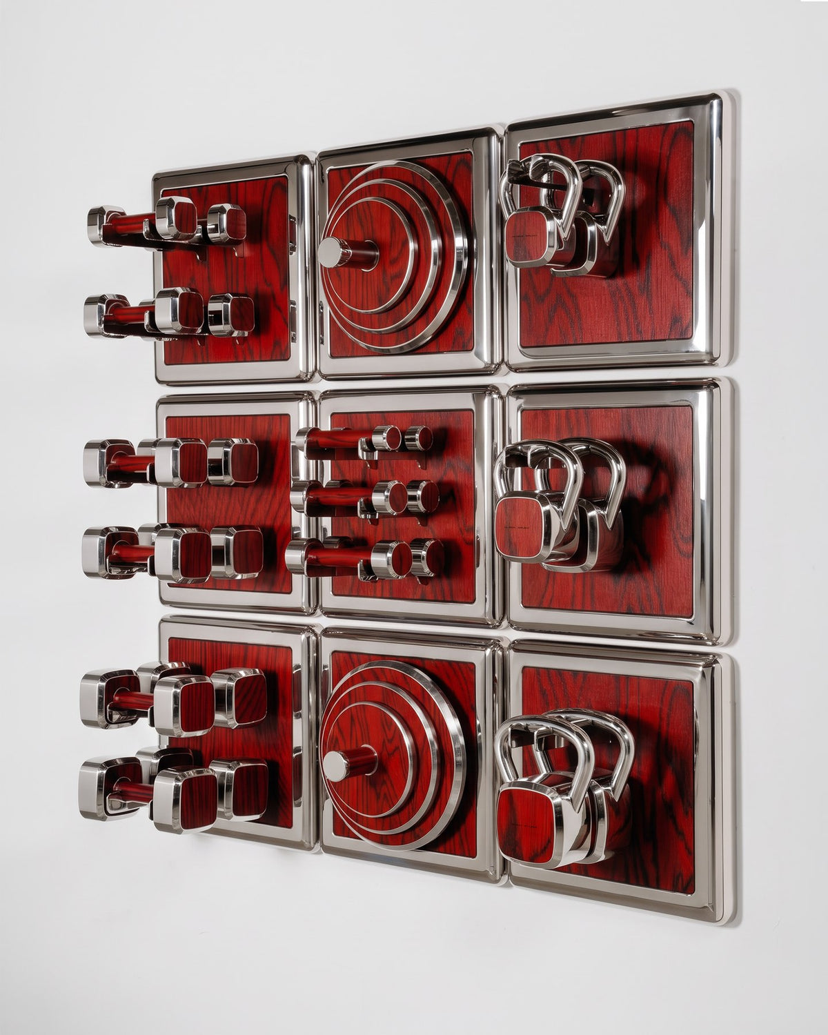 ALAMA twelve-module wall configuration example in ALPI Sottsass Red and mirror-polished steel, with illustrative equipment. Standard offer: nine modules.