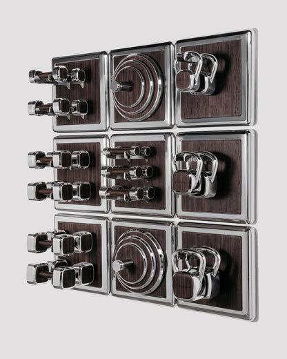 ALAMA twelve-module wall configuration example in ALPI Flamed Kakao and mirror-polished steel, with illustrative equipment. Standard offer: nine modules.