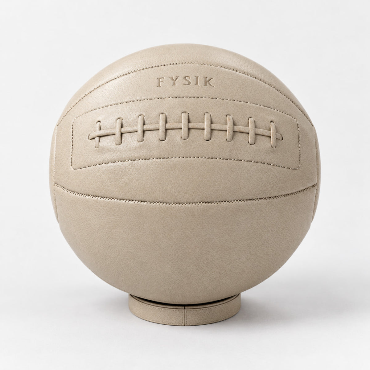 Bonn Medicine Ball — front view; Grey Ash wood, beige leather and natural stainless steel where applicable. FYSIK studio finish study — October 2026. Representative configuration.