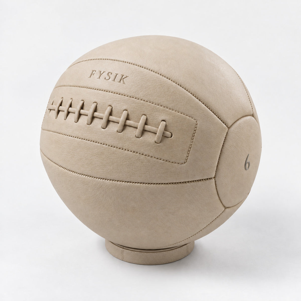 Bonn Medicine Ball — angled view; Grey Ash wood, beige leather and natural stainless steel where applicable. FYSIK studio finish study — October 2026. Representative configuration.