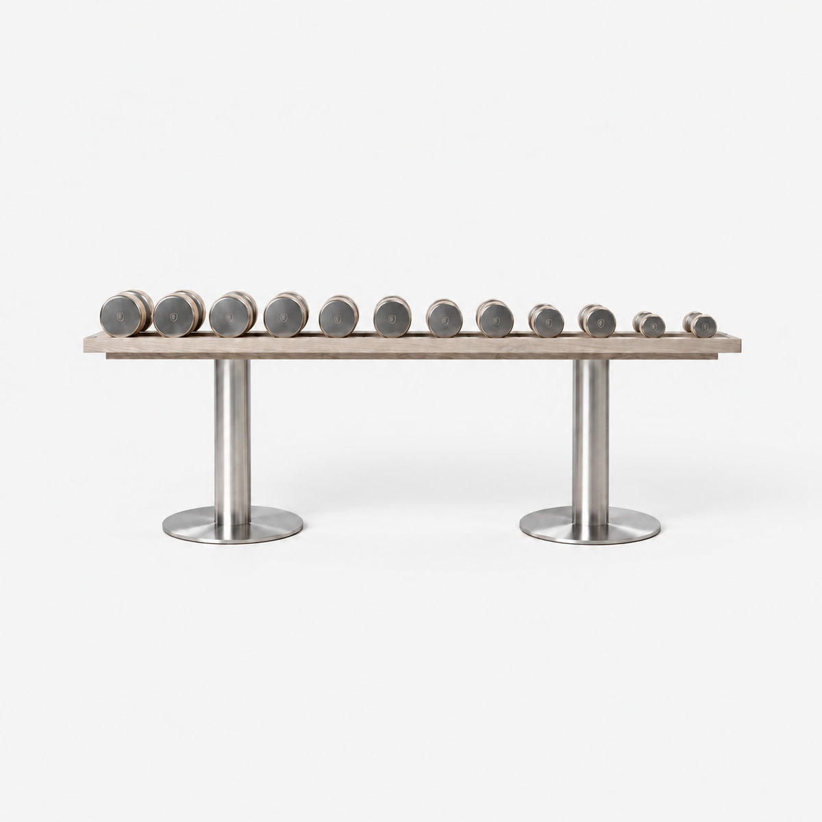 Fysik Horizontal Dumbbell Rack — front view; Grey Ash wood, beige leather and natural stainless steel where applicable. FYSIK studio finish study — October 2026. Representative configuration.