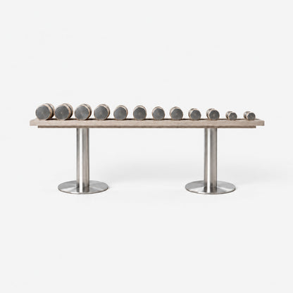 Fysik Horizontal Dumbbell Rack — front view; Grey Ash wood, beige leather and natural stainless steel where applicable. FYSIK studio finish study — October 2026. Representative configuration.