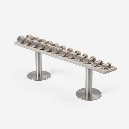 Fysik Horizontal Dumbbell Rack — angled view; Grey Ash wood, beige leather and natural stainless steel where applicable. FYSIK studio finish study — October 2026. Representative configuration.
