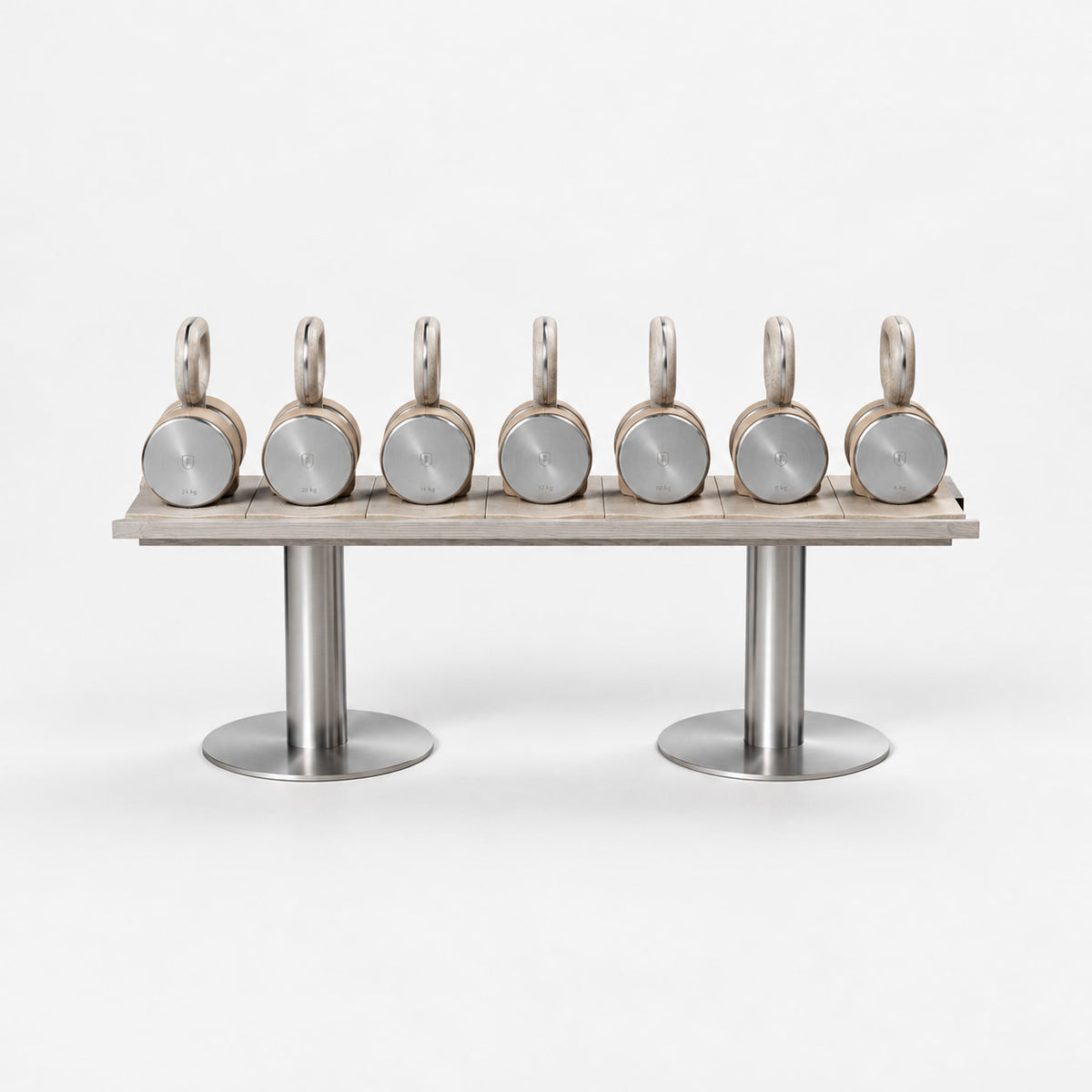 Fysik Horizontal Kettlebell Rack — front view; Grey Ash wood, beige leather and natural stainless steel where applicable. FYSIK studio finish study — October 2026. Representative configuration.