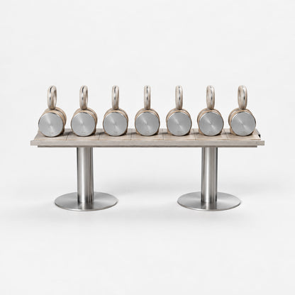 Fysik Horizontal Kettlebell Rack — front view; Grey Ash wood, beige leather and natural stainless steel where applicable. FYSIK studio finish study — October 2026. Representative configuration.