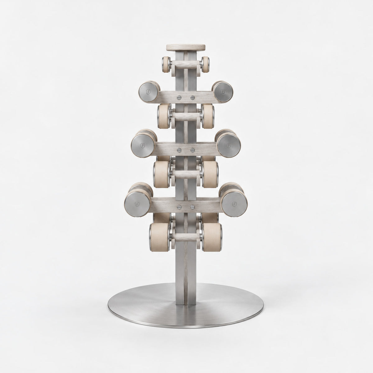 Fysik Vertical Dumbbell Tower — front view; Grey Ash wood, beige leather and natural stainless steel where applicable. FYSIK studio finish study — October 2026. Representative configuration.