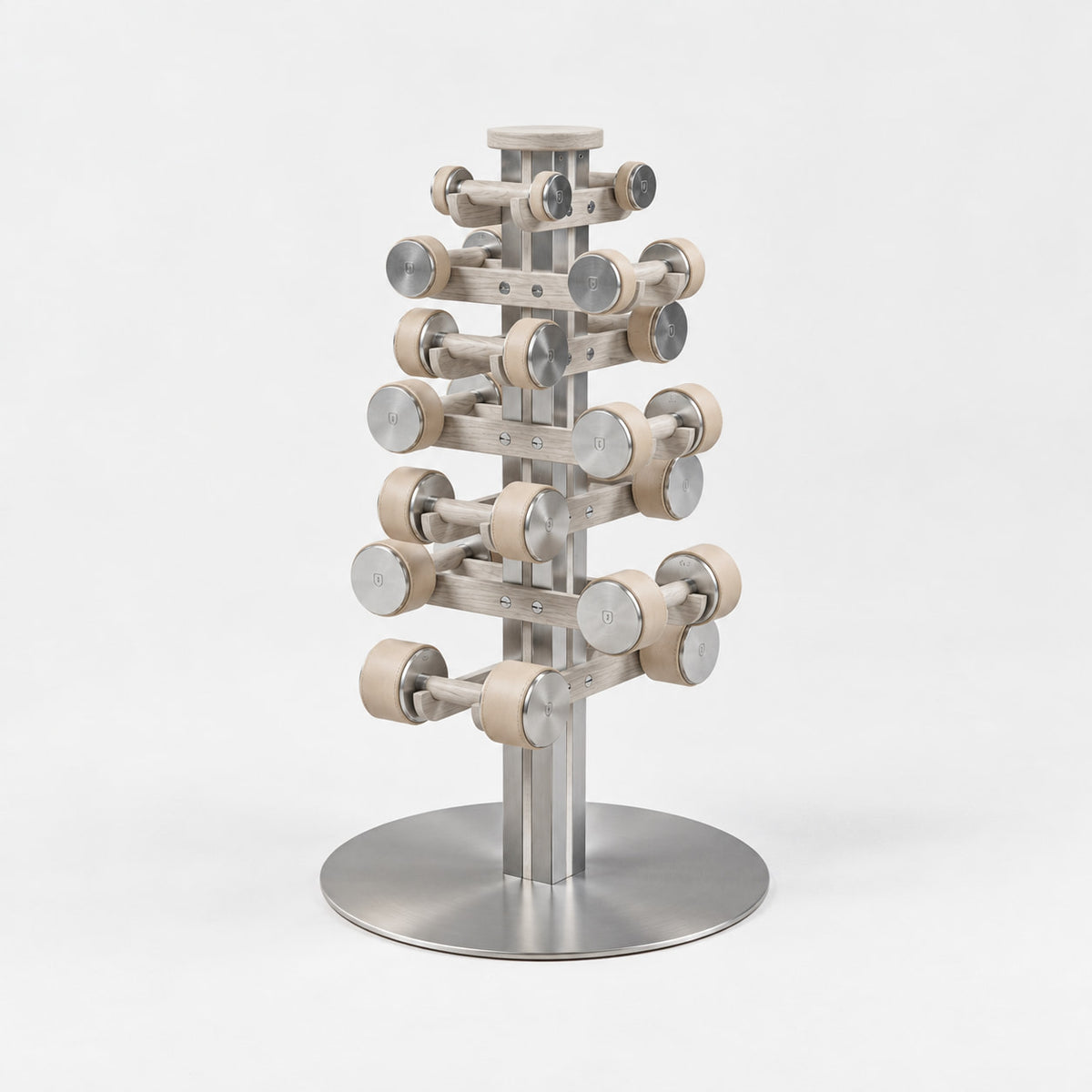 Fysik Vertical Dumbbell Tower — angled view; Grey Ash wood, beige leather and natural stainless steel where applicable. FYSIK studio finish study — October 2026. Representative configuration.