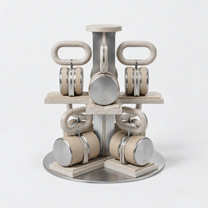 Fysik Vertical Kettlebell Tower — front view; Grey Ash wood, beige leather and natural stainless steel where applicable. FYSIK studio finish study — October 2026. Representative configuration.