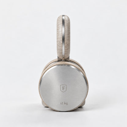 Kraba Individual Kettlebell — front view; Grey Ash wood, beige leather and natural stainless steel where applicable. FYSIK studio finish study — October 2026. Representative configuration.