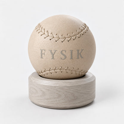 Lek Massage Ball — front view; Grey Ash wood, beige leather and natural stainless steel where applicable. FYSIK studio finish study — October 2026. Representative configuration.