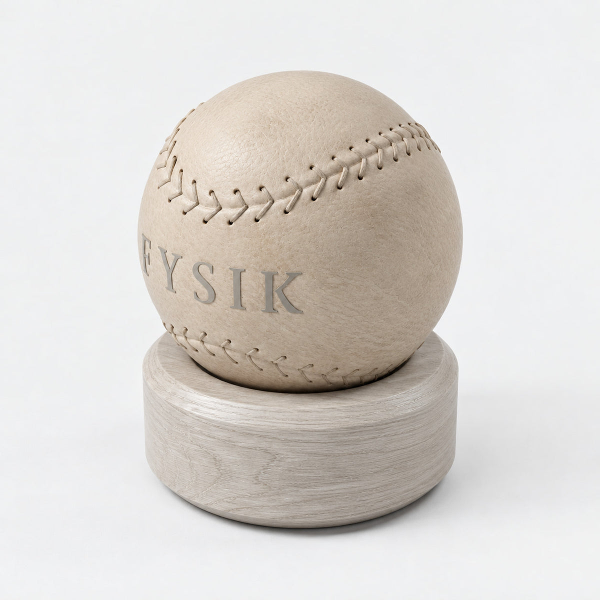 Lek Massage Ball — angled view; Grey Ash wood, beige leather and natural stainless steel where applicable. FYSIK studio finish study — October 2026. Representative configuration.
