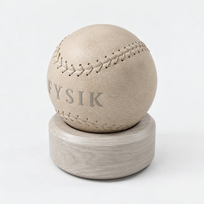 Lek Massage Ball — angled view; Grey Ash wood, beige leather and natural stainless steel where applicable. FYSIK studio finish study — October 2026. Representative configuration.