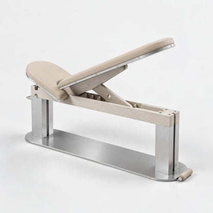 Nang Adjustable Gym Bench — angled view; Grey Ash wood, beige leather and natural stainless steel where applicable. FYSIK studio finish study — October 2026. Representative configuration.