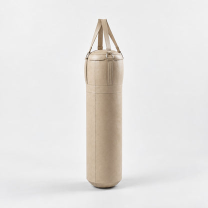 Sai Boxing Bag — angled view; Grey Ash wood, beige leather and natural stainless steel where applicable. FYSIK studio finish study — October 2026. Representative configuration.