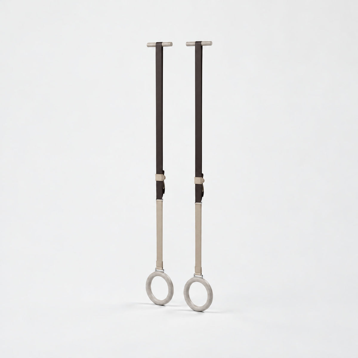 Waen Gymnastics Rings — angled view; Grey Ash wood, beige leather and natural stainless steel where applicable. FYSIK studio finish study — October 2026. Representative configuration.