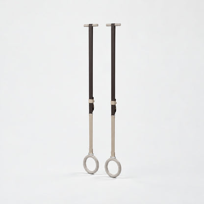 Waen Gymnastics Rings — angled view; Grey Ash wood, beige leather and natural stainless steel where applicable. FYSIK studio finish study — October 2026. Representative configuration.