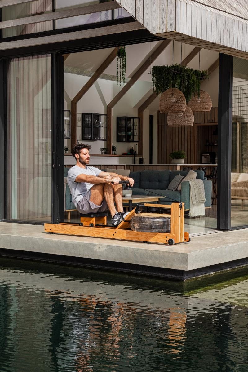 WaterRower Original in use beside a reflecting pool