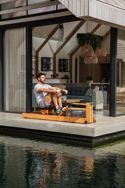 WaterRower Original in use beside a reflecting pool